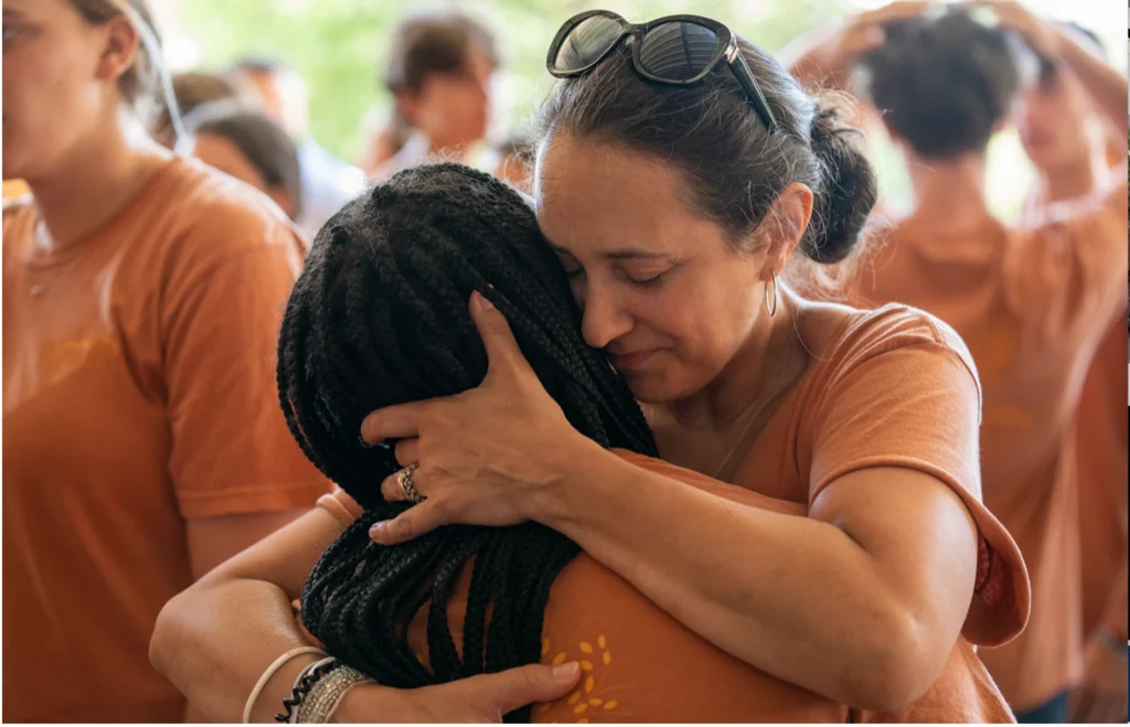 Two women embracing after the Sunday gathering