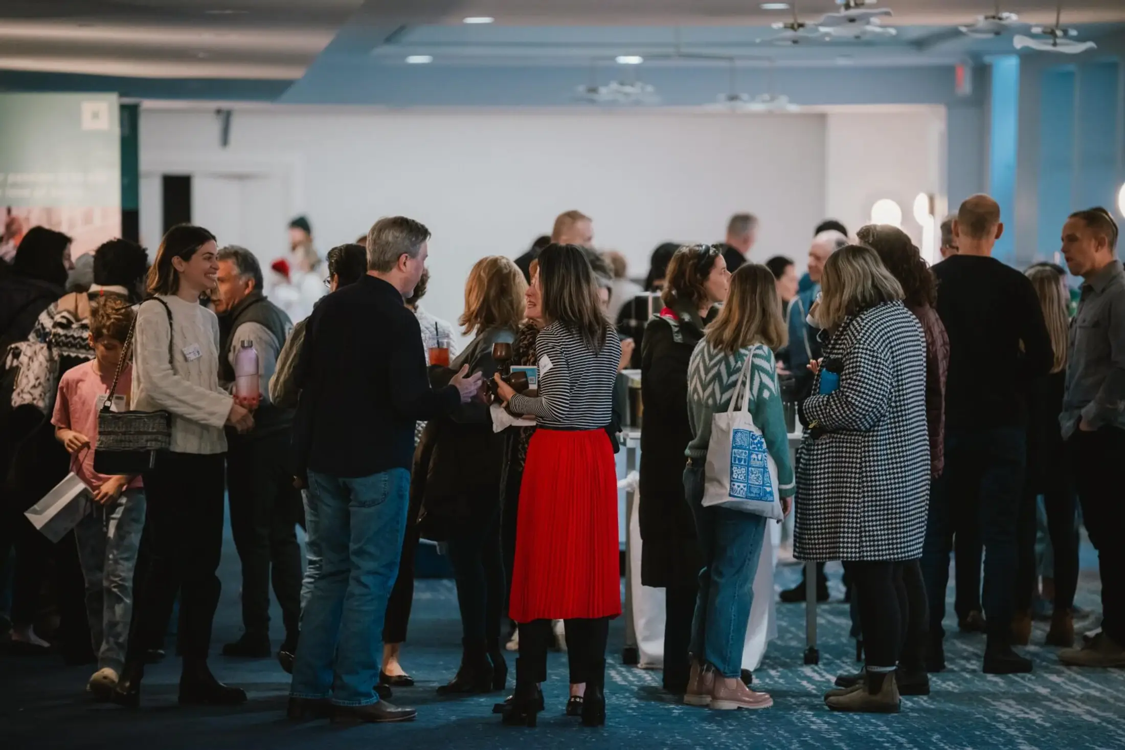 People talking and laughing in the lobby after a Sunday gathering at Trinity Church