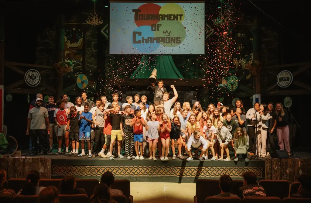 Trinity Youth students cheering on stage at SummerQuest