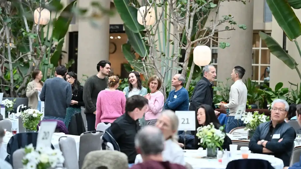 Friends talking between tables at Brunch Church in the Hyatt atrium